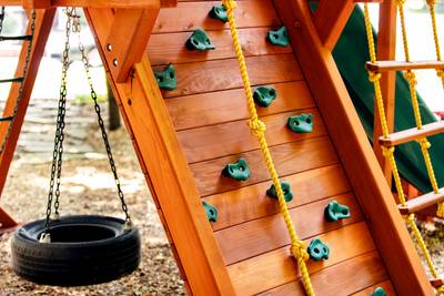 wooden backyard playset rock wall and tire swing